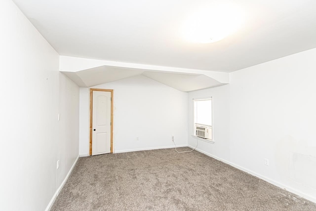 spare room with carpet floors, lofted ceiling, cooling unit, and baseboards