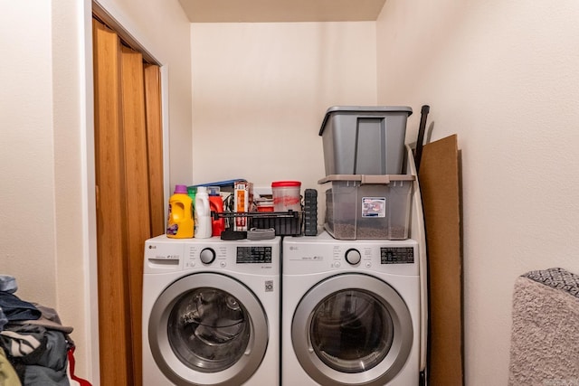 clothes washing area featuring laundry area and washer and clothes dryer