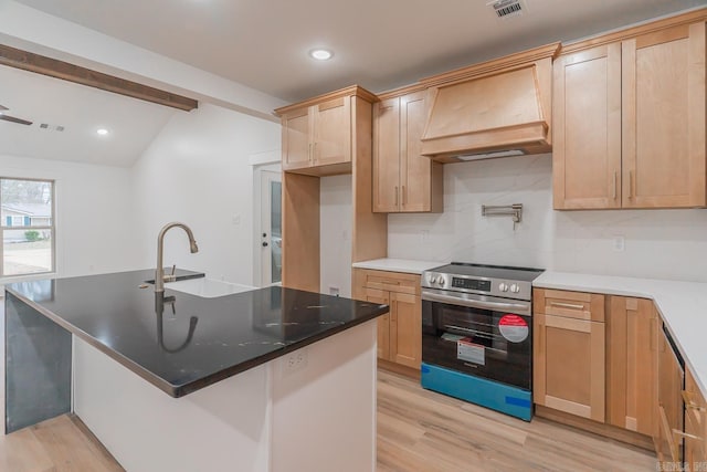 kitchen featuring stainless steel electric stove, light wood finished floors, a sink, and custom range hood