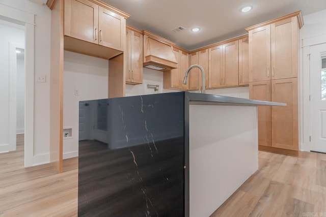 kitchen with light wood-style floors, recessed lighting, a sink, and light brown cabinetry