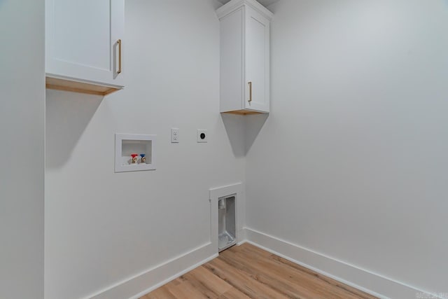 laundry area featuring hookup for a washing machine, light wood-style floors, baseboards, cabinet space, and electric dryer hookup