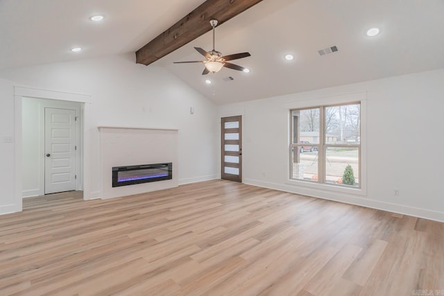 unfurnished living room featuring vaulted ceiling with beams, light wood finished floors, visible vents, and a glass covered fireplace