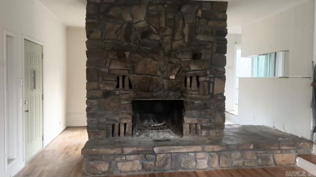 details with a fireplace and wood finished floors