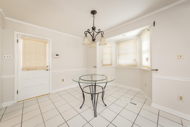 unfurnished dining area with baseboards, a chandelier, and crown molding