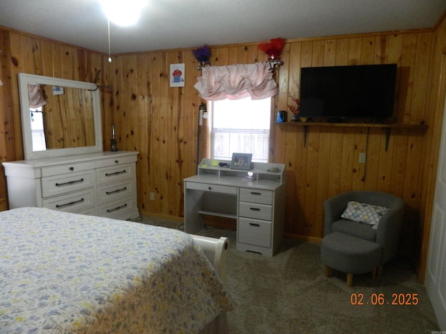 bedroom with carpet floors and wood walls