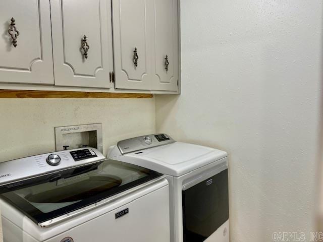 laundry room with cabinet space and washing machine and clothes dryer