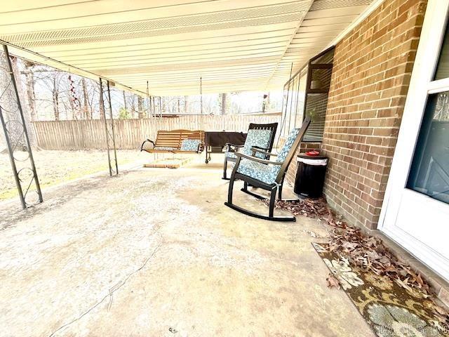 view of patio featuring outdoor lounge area and fence