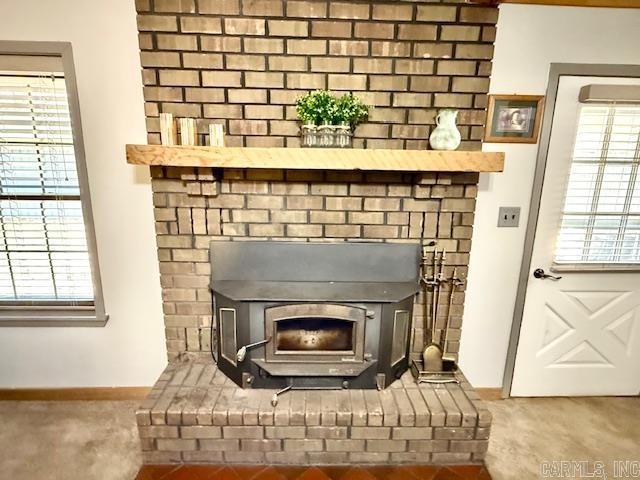 interior details with a wood stove and baseboards