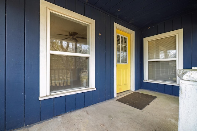 doorway to property with a porch and board and batten siding