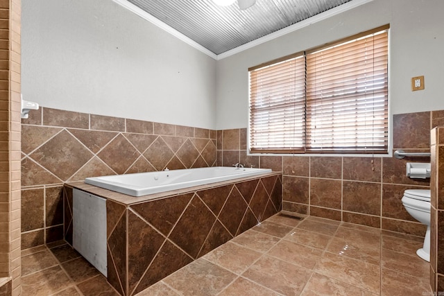 1580 Ridge Rd, El Paso, AR 72045 - bathroom featuring toilet, ornamental molding, a garden tub, tile patterned flooring, and tile walls