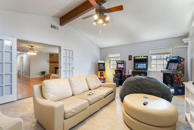 living area featuring a wealth of natural light, french doors, visible vents, and lofted ceiling with beams