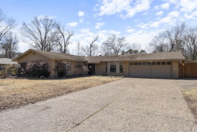 ranch-style house featuring brick siding, driveway, and an attached garage