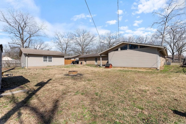 view of yard featuring an outdoor fire pit and fence