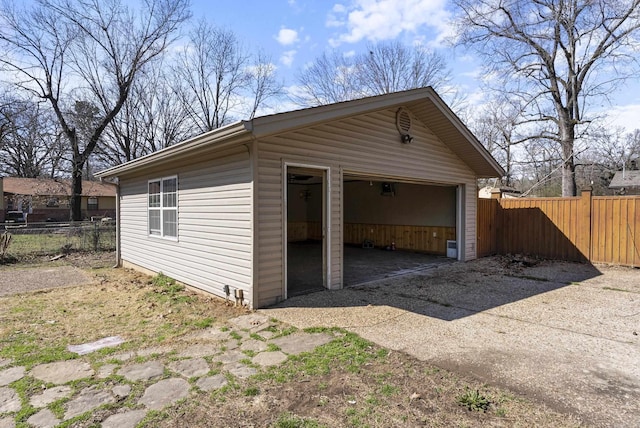 detached garage featuring fence