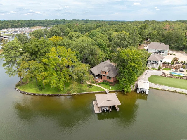 bird's eye view with a water view and a wooded view