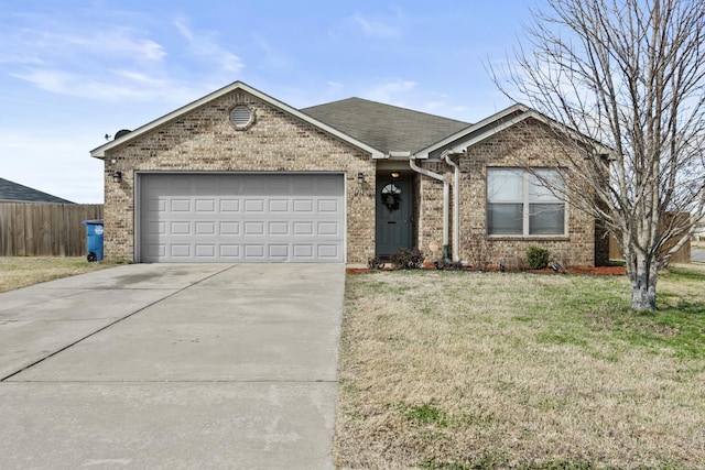 ranch-style home with a garage, concrete driveway, fence, a front yard, and brick siding