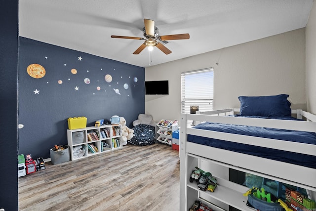 bedroom with a ceiling fan and wood finished floors