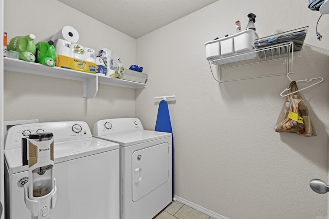 laundry room with laundry area, light tile patterned flooring, baseboards, and separate washer and dryer