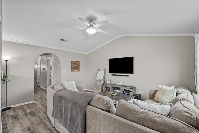 living room with arched walkways, lofted ceiling, visible vents, ornamental molding, and wood finished floors