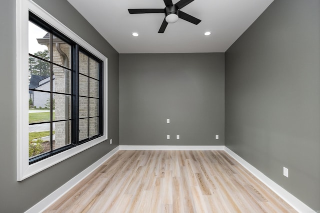 unfurnished room featuring a healthy amount of sunlight, light wood-style flooring, and baseboards