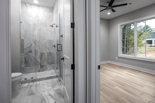 bathroom with toilet, a stall shower, visible vents, and baseboards