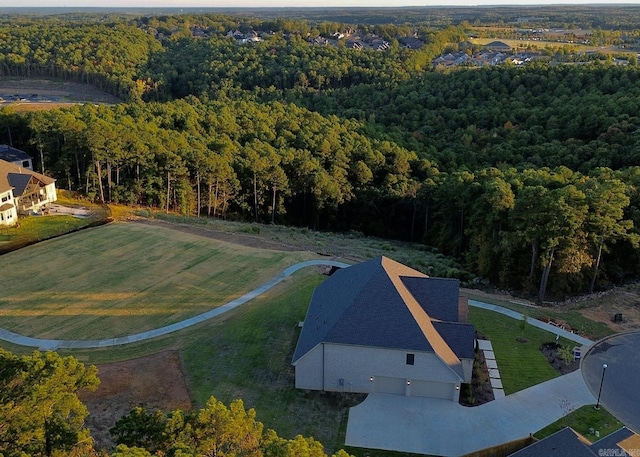 birds eye view of property featuring a view of trees