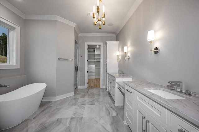 full bathroom featuring marble finish floor, a soaking tub, two vanities, ornamental molding, and a sink