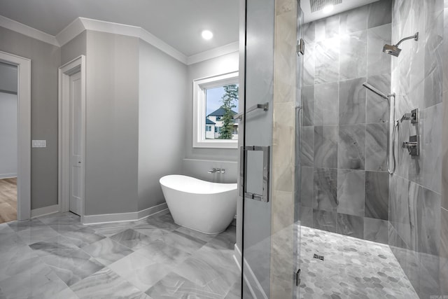 bathroom with ornamental molding, a freestanding bath, a shower stall, and baseboards