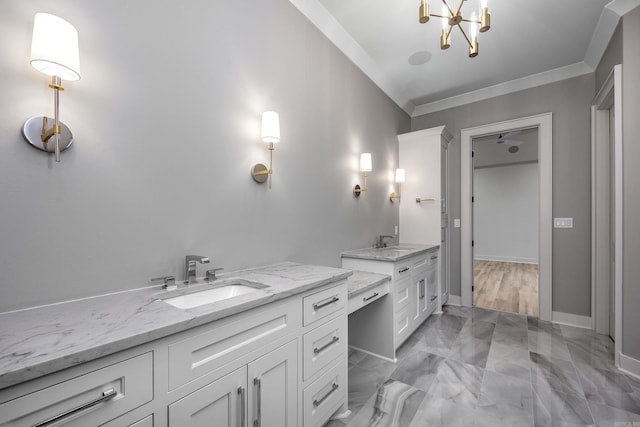 full bath with baseboards, ornamental molding, two vanities, and a sink