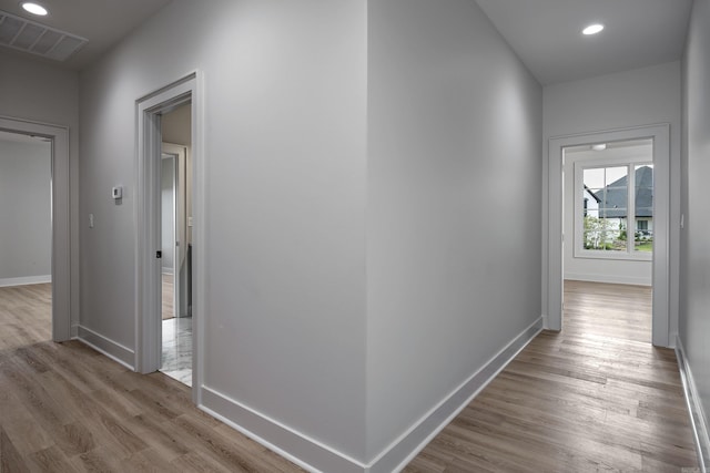 corridor with recessed lighting, wood finished floors, visible vents, and baseboards