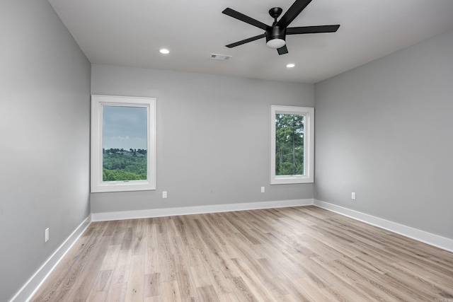 unfurnished room featuring light wood-style floors, baseboards, and visible vents