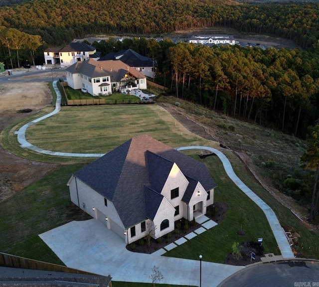 drone / aerial view with a wooded view