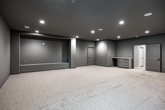 home theater room with baseboards, visible vents, light colored carpet, and recessed lighting