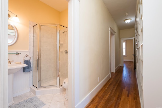 corridor with wainscoting and tile patterned floors