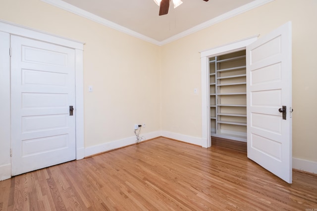 interior space with light wood finished floors, ceiling fan, baseboards, and crown molding