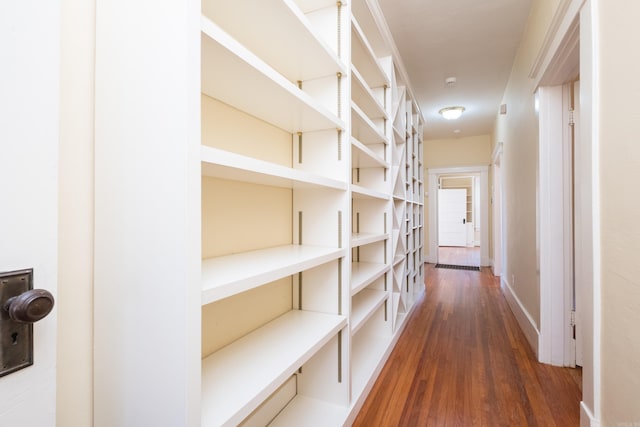 hall featuring baseboards and wood finished floors