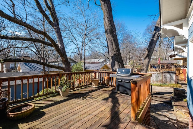 wooden deck featuring a grill