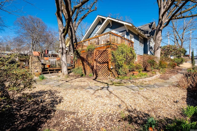 view of side of home with a wooden deck