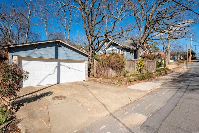 view of side of property with fence and an outdoor structure