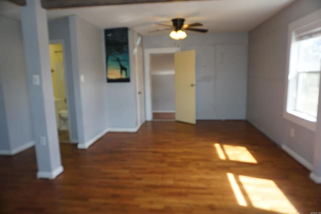 interior space featuring ceiling fan, baseboards, and wood finished floors