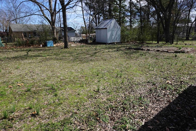 view of yard featuring a fenced backyard, an outdoor structure, and a storage unit