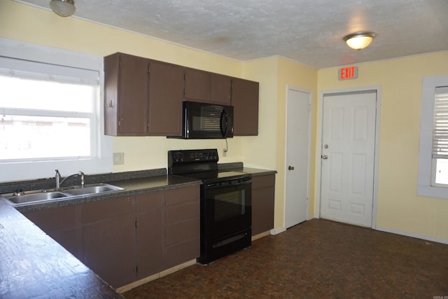 kitchen featuring black appliances, dark countertops, a sink, and baseboards