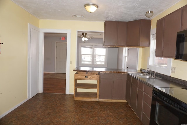 kitchen featuring baseboards, visible vents, a sink, and black appliances