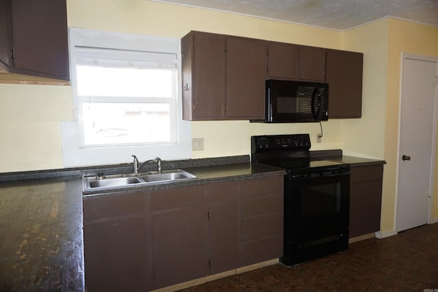 kitchen featuring dark countertops, a sink, and black appliances