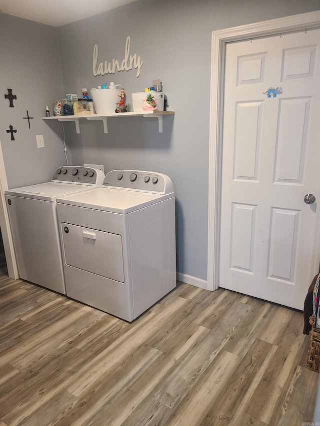 laundry room with baseboards, laundry area, independent washer and dryer, and light wood-style floors