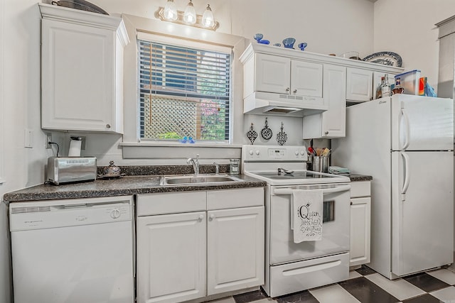 kitchen with dark countertops, white appliances, under cabinet range hood, and a sink