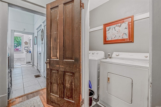 washroom featuring laundry area, wood finished floors, and washer and dryer