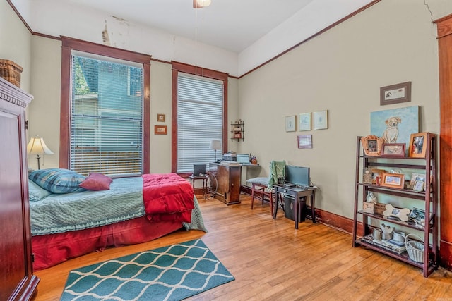 bedroom with baseboards and wood finished floors