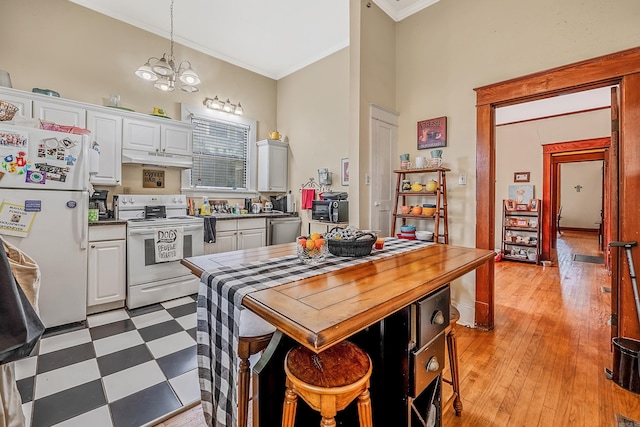 kitchen featuring a notable chandelier, white appliances, white cabinetry, ornamental molding, and light floors