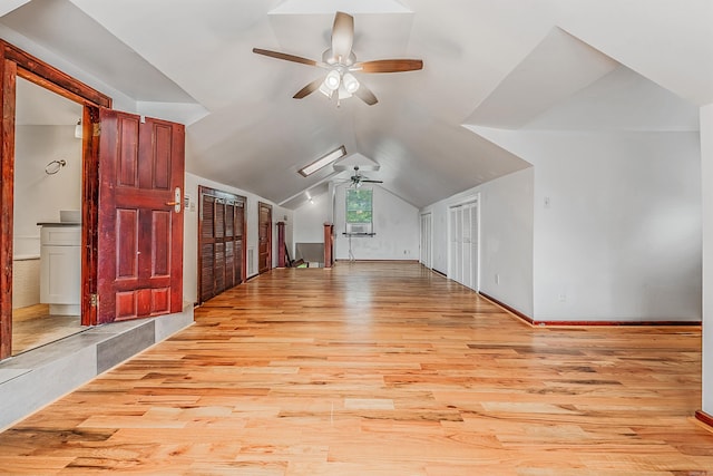 bonus room featuring lofted ceiling, light wood-type flooring, and a ceiling fan